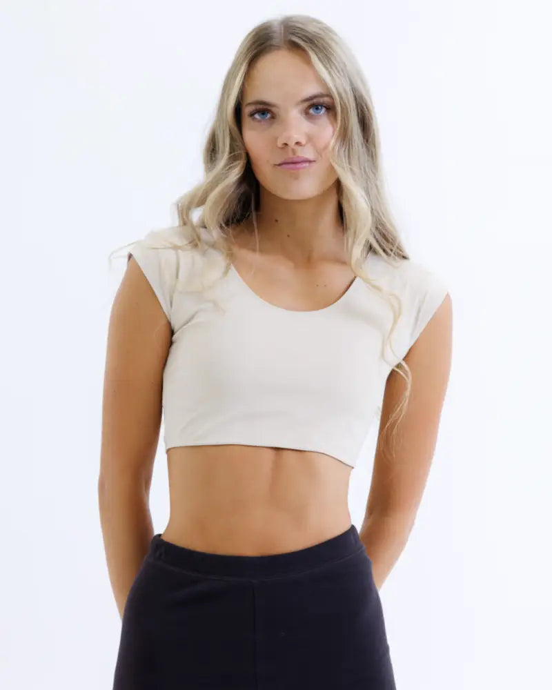 Cream-colored contour demi cropped shaping tee with short flared sleeves and moisture wicking fabric