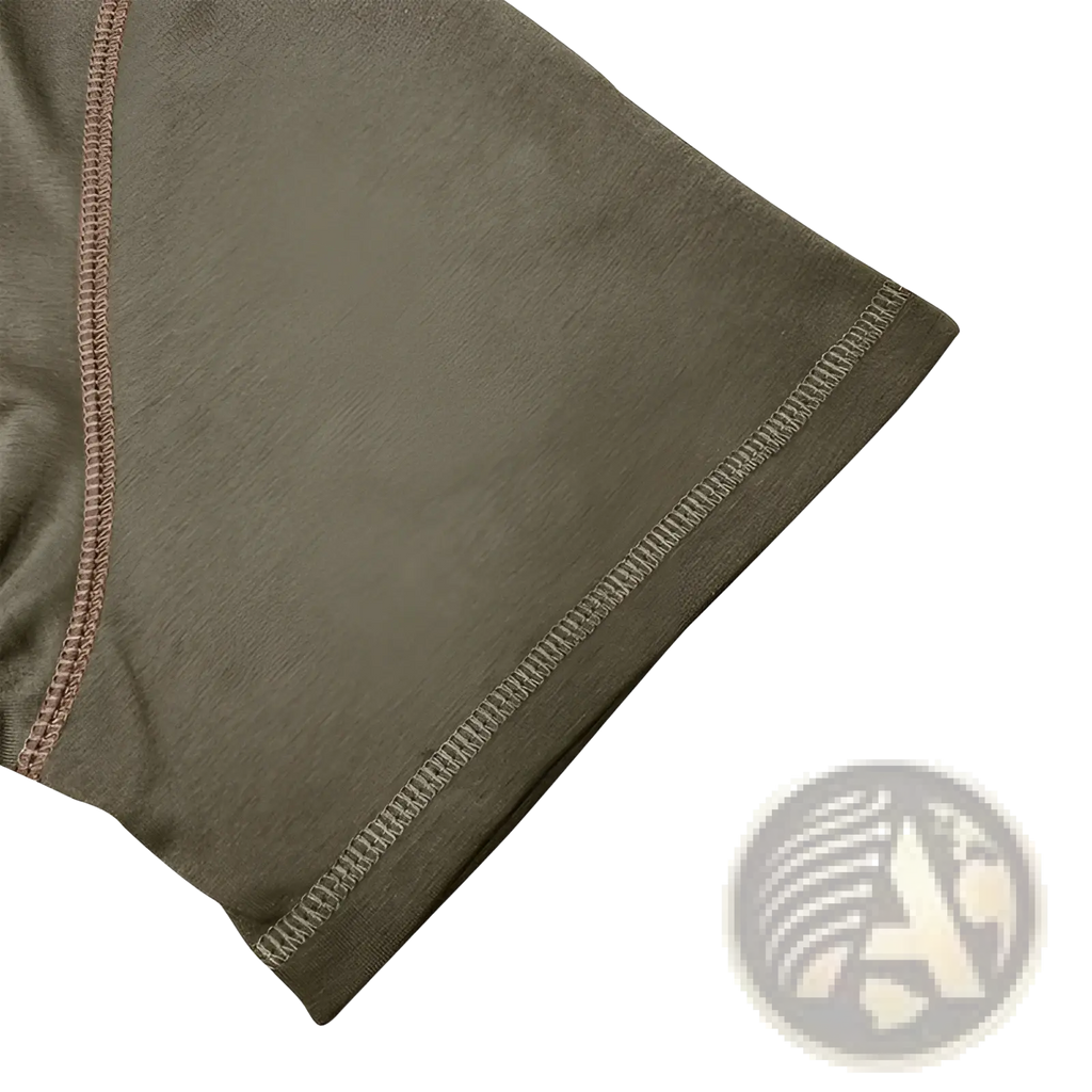 Olive green athletic shorts with contrasting pink and white stitching along the hem paired with a contrast trim henley polo shirt