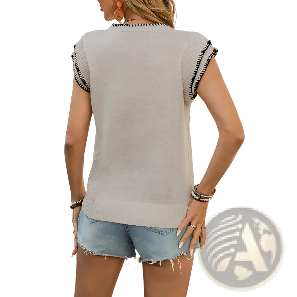 Beige sleeveless knit top with black contrast trim along shoulders and neckline for stylish casual wear
