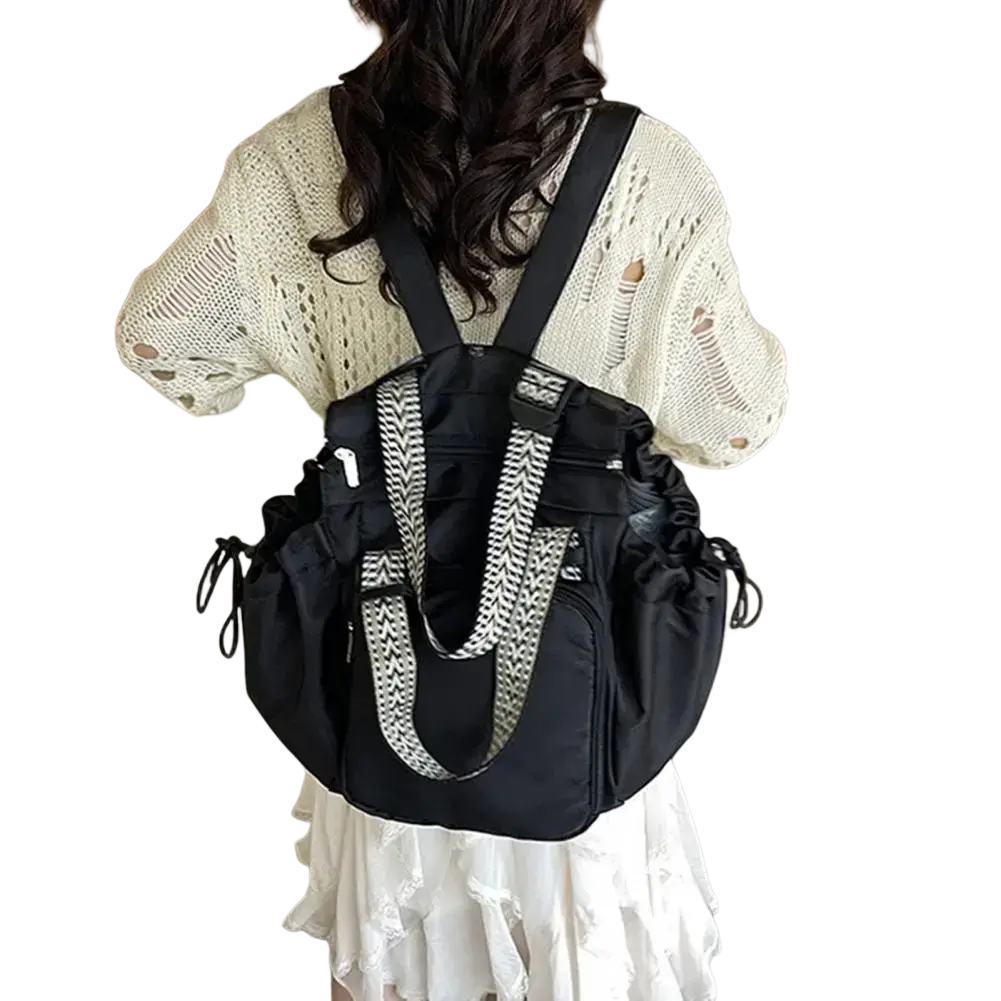 Black nylon convertible tote backpack with large capacity and black and white geometric-patterned shoulder straps