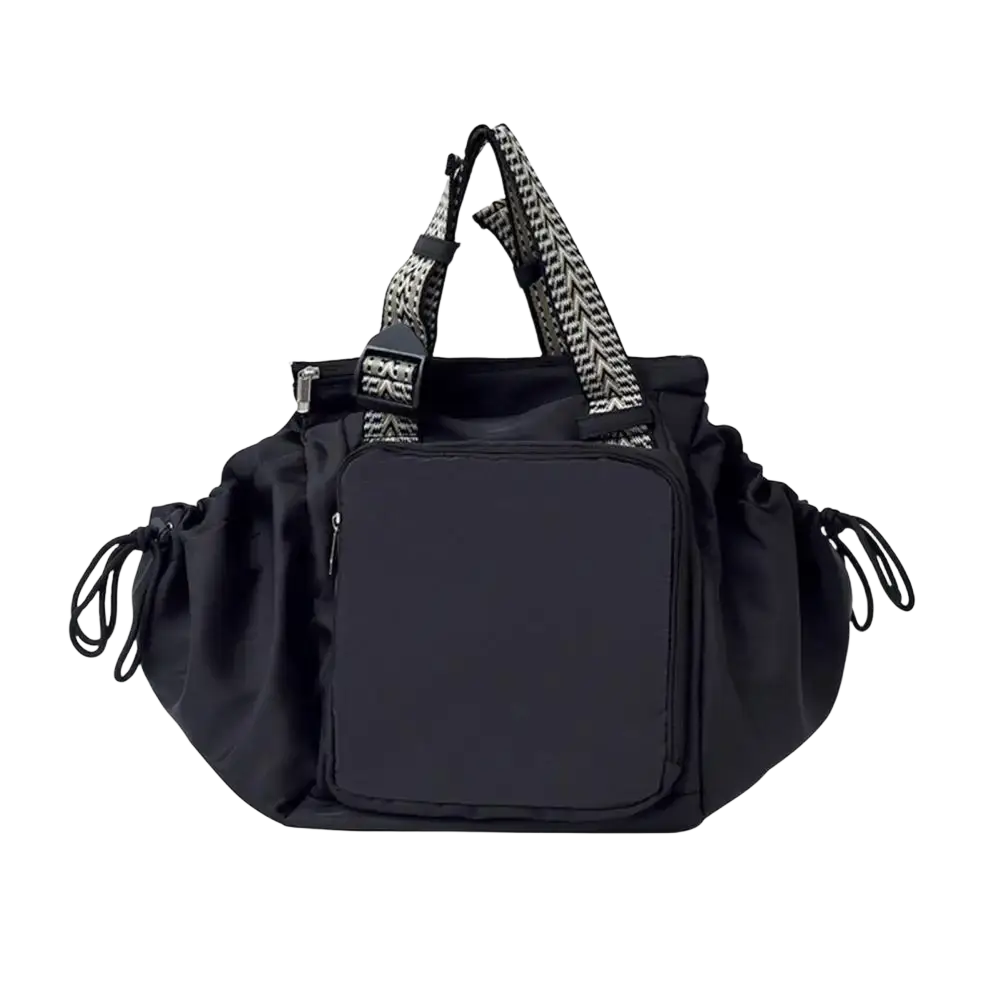 Black nylon convertible tote backpack with large capacity, patterned shoulder straps, and front zippered pocket