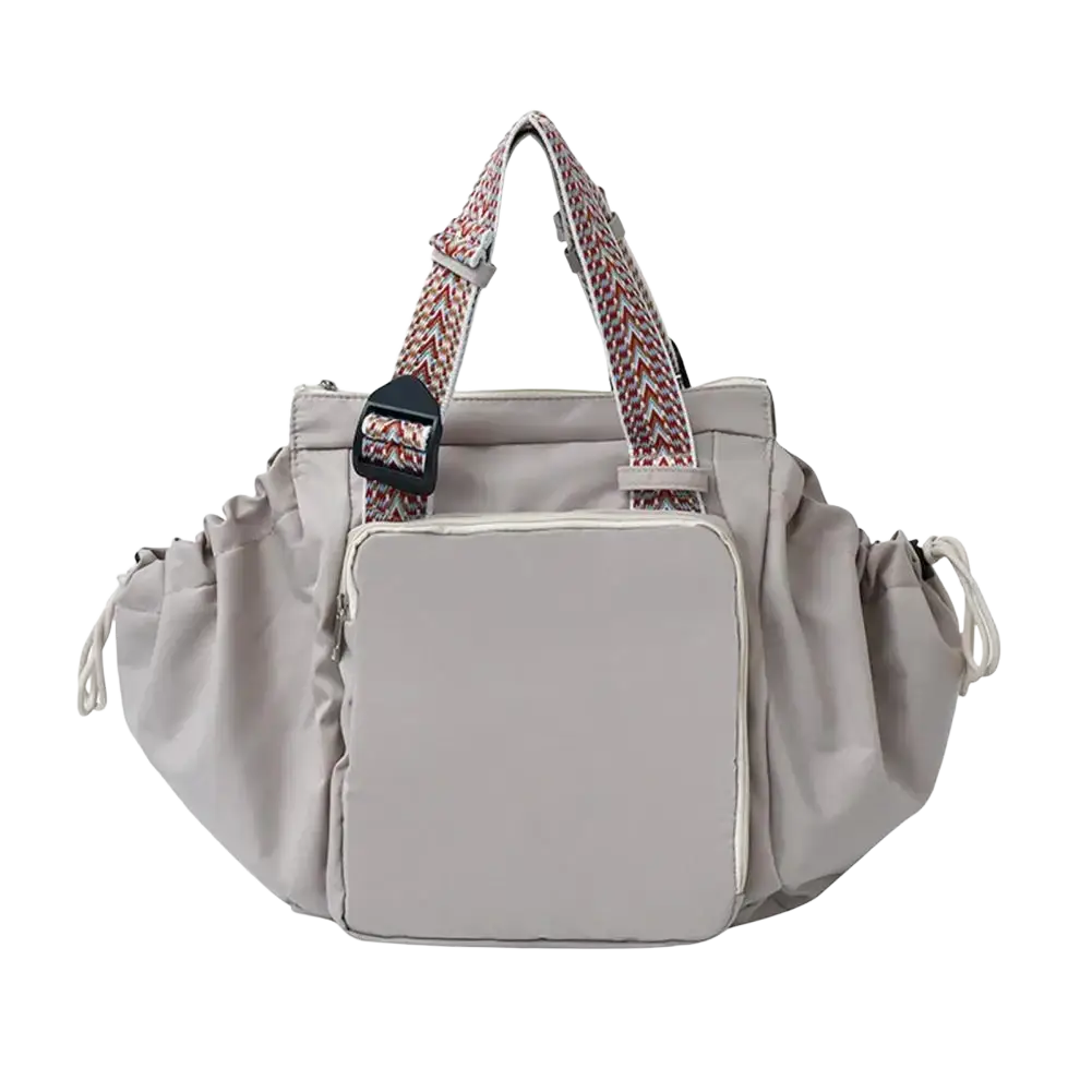 Gray nylon convertible tote backpack with large capacity, patterned handles, and a front pocket for organized storage