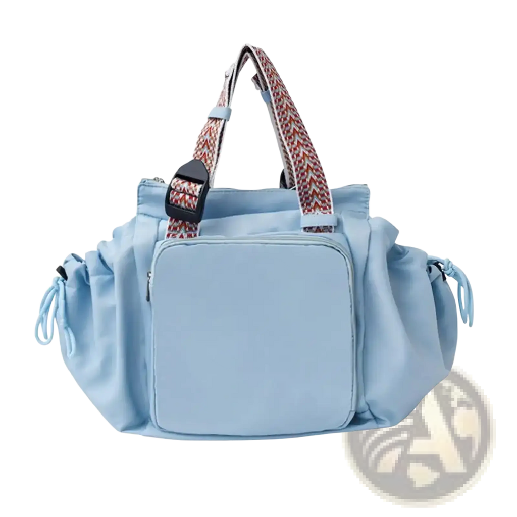 Light blue nylon convertible tote backpack with patterned woven straps and front zippered compartment