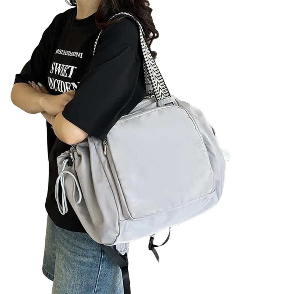 Light gray nylon convertible tote backpack with large capacity and black and white herringbone shoulder strap