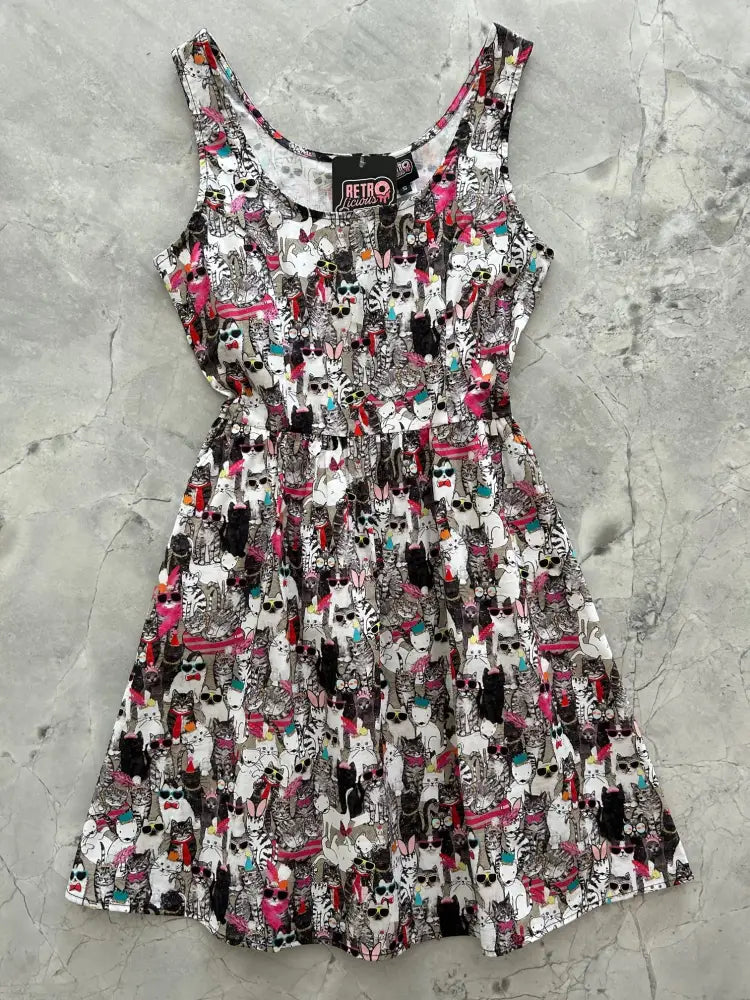 A playful sleeveless cool cats retro dress with a vibrant cartoon cat pattern in black white pink and teal on light background
