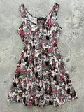 A playful sleeveless cool cats retro dress with a vibrant cartoon cat pattern in black white pink and teal on light background