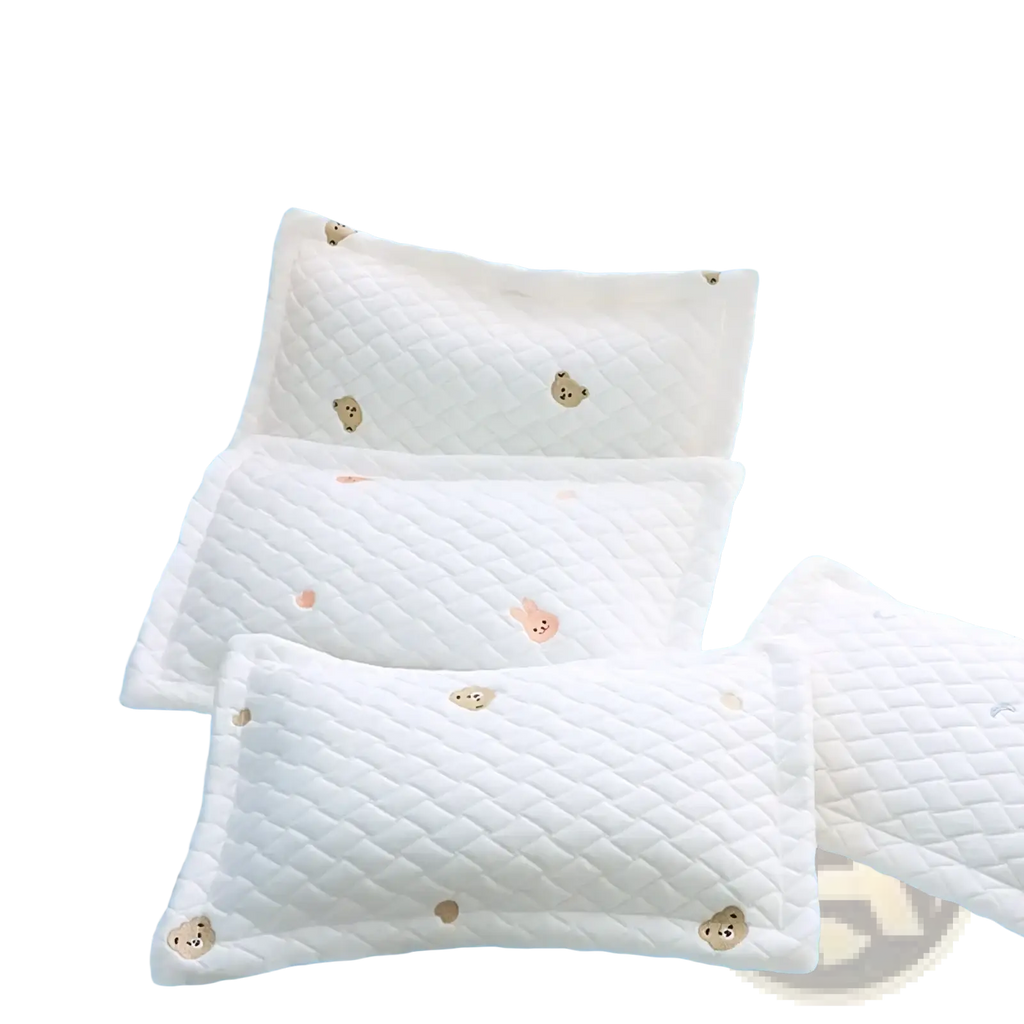 White quilted baby pillow with cool polymer ice silk fabric and embroidered bear faces for infant comfort
