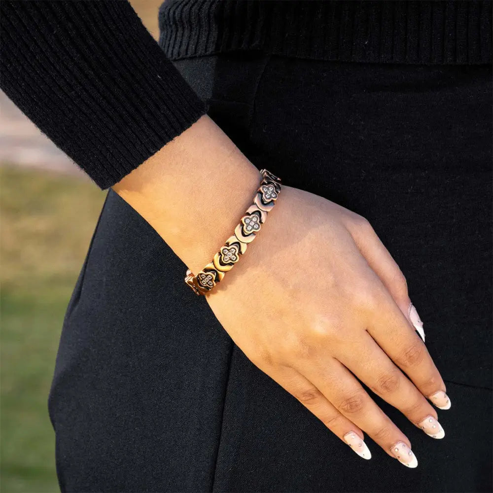 Rose gold copper clover magnetic bracelet with gold-toned clover-shaped links and clear cz crystals embedded