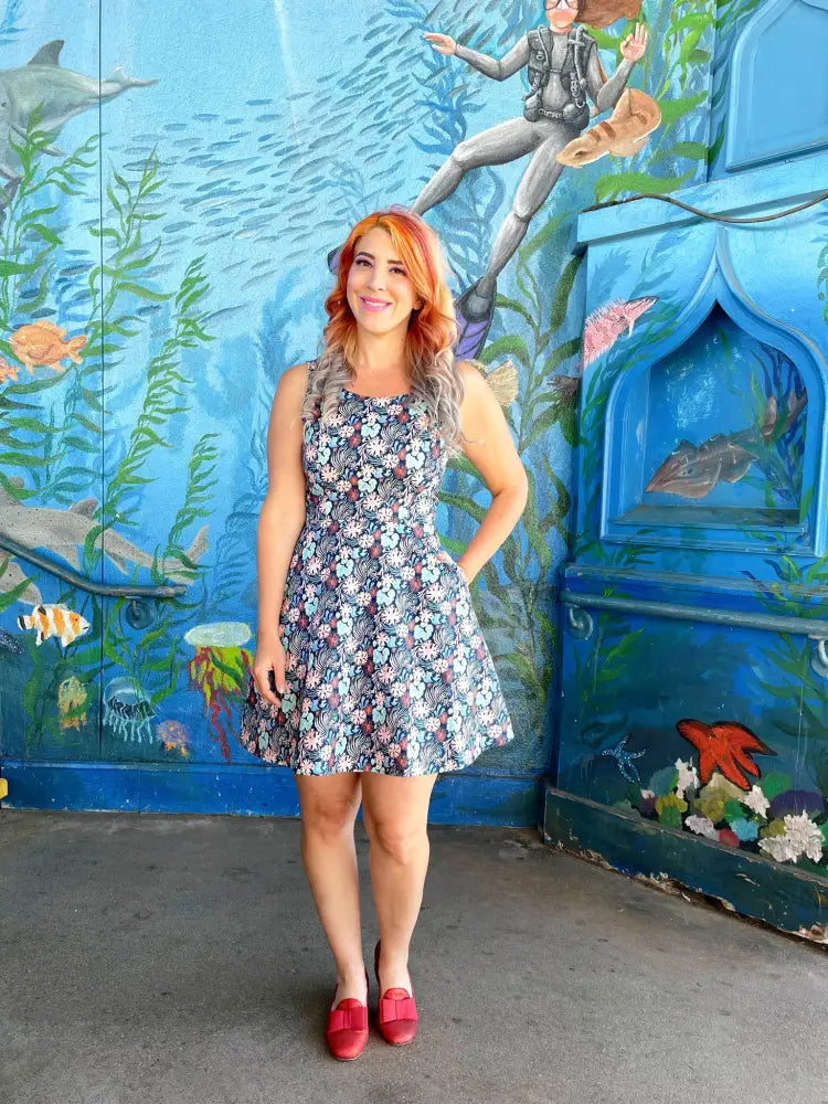 Coral floral sleeveless skater dress with pockets in gray white and pink floral print with a flared skirt