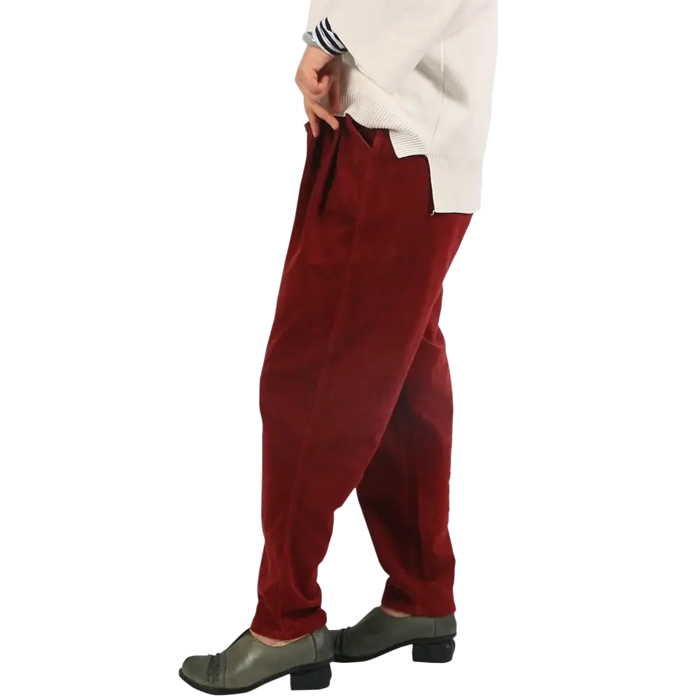 Crimped red corduroy wide leg pants with elastic waist relaxed fit and visible seam detailing in detailed images