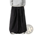 Black corduroy wide leg pants for men with a relaxed silhouette and drawstring waist