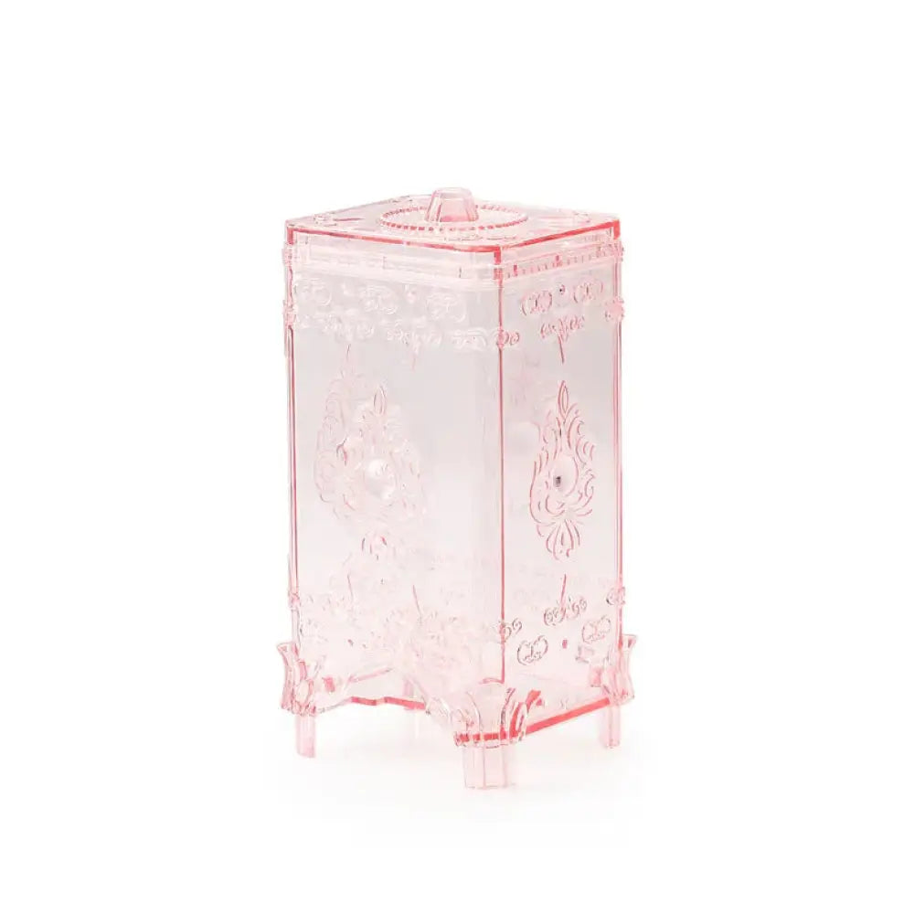 Ornate embossed amber glass cosmetic storage box made of translucent pink plastic with floral decorative patterns