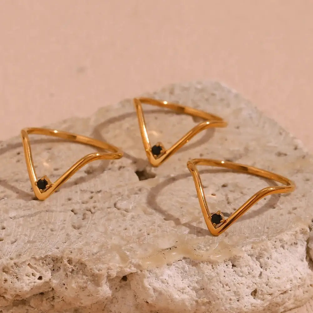 Cosmo Gold v shape waterproof gold ring featuring a black gemstone at each triangle vertex