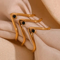Cosmo gold v shape waterproof ring in gold tone with black gemstone accents and geometric design