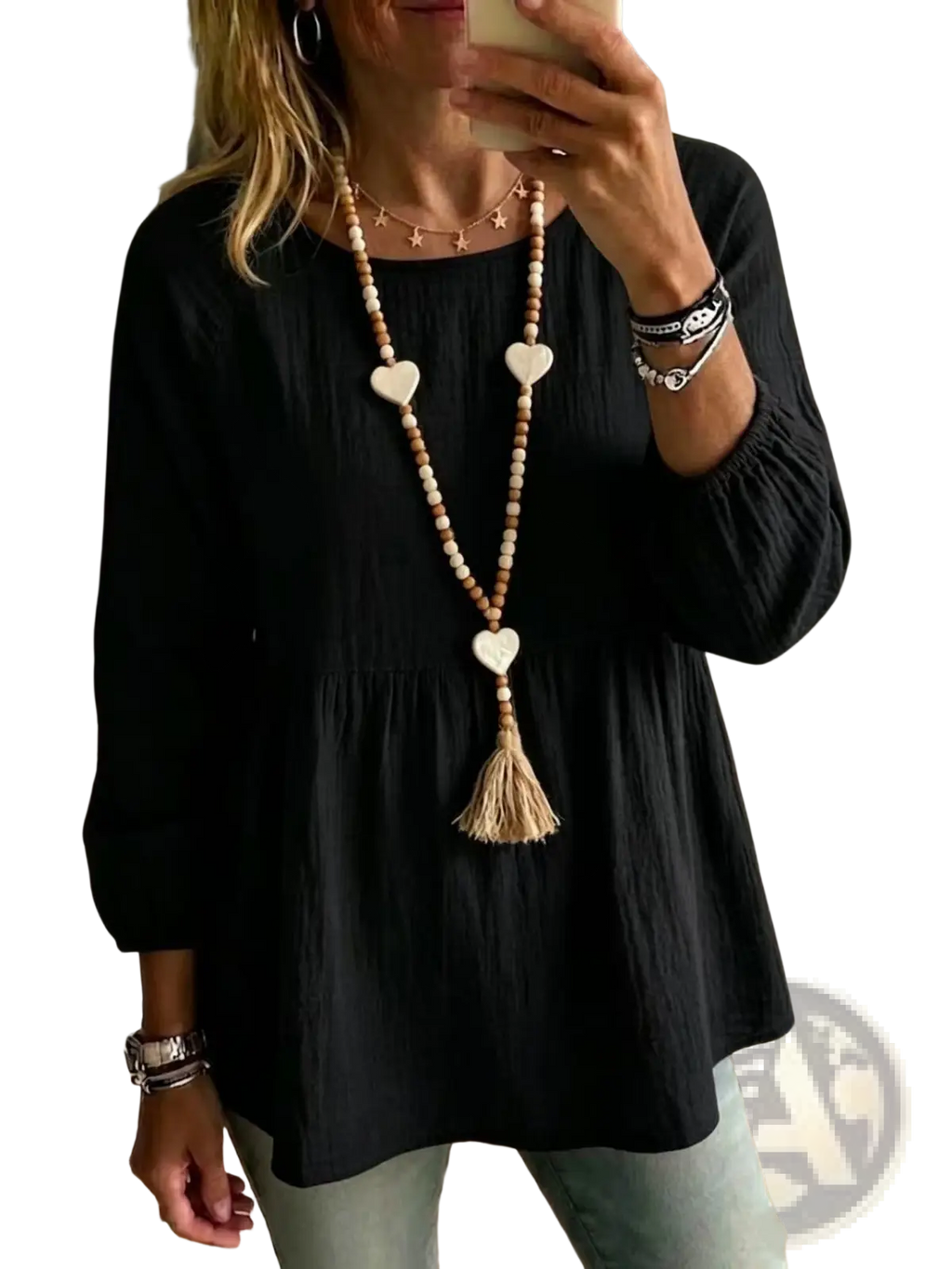 A long boho-style necklace with wooden beads white heart-shaped pendants and tassel paired with cotton doll shirt loose fit top
