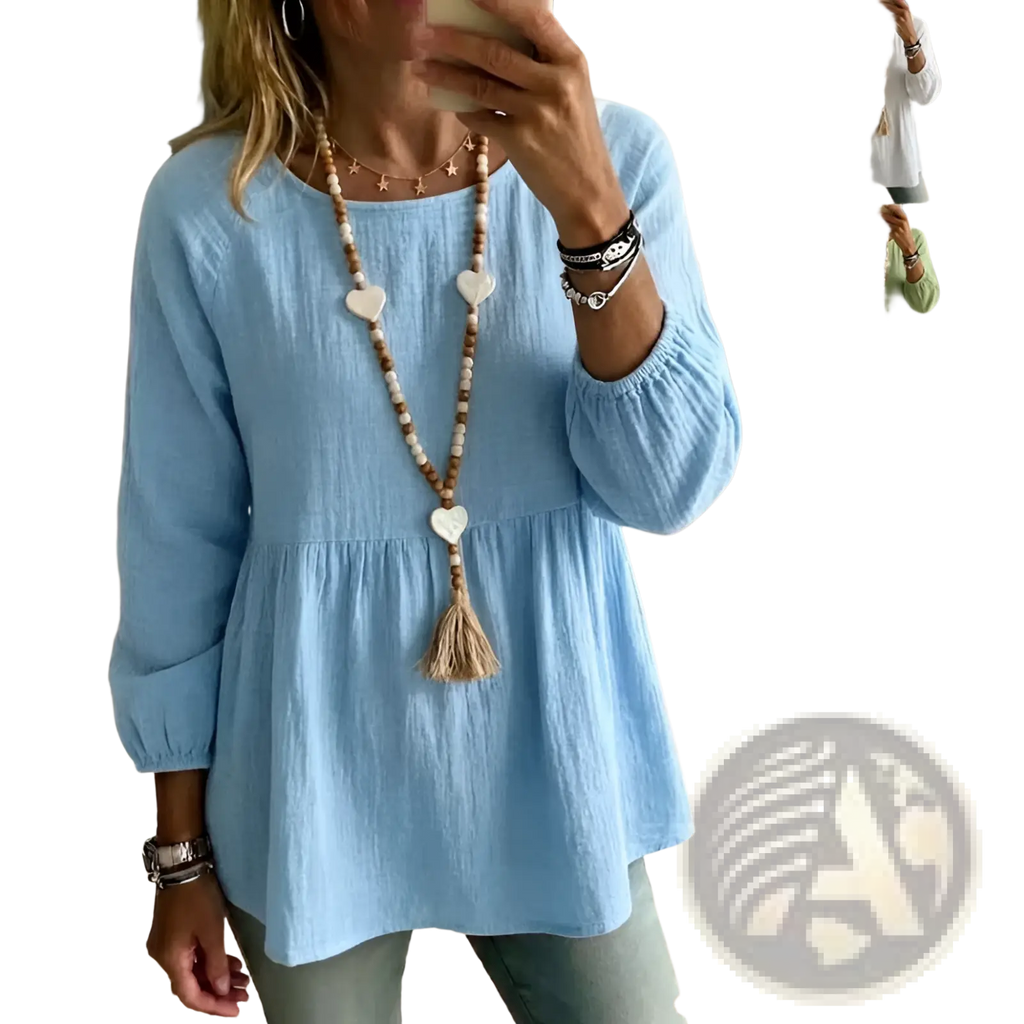 Light blue cotton doll shirt with loose fit, gathered waist, and elastic cuffs for casual wear