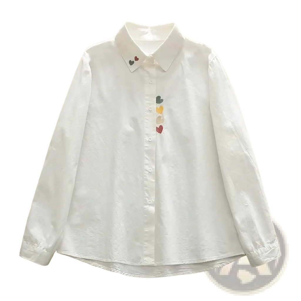 White cotton long-sleeved button up blouse with colorful heart embroidery along the placket and collar
