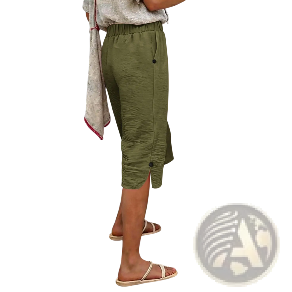 Olive green cotton linen capri pants with high waist and black button details in textured fabric