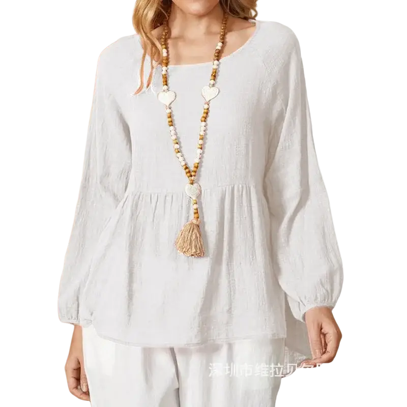 A white cotton linen long sleeve loose blouse with a relaxed fit and puffed sleeves