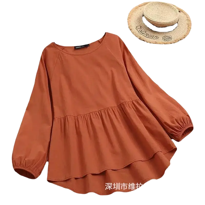A soft rust-colored cotton linen long sleeve blouse with tiered peplum hem and elastic cuffs