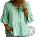 Mint green cotton linen pleated blouse top with tiered design, ruffled sleeves, and tie-front neckline