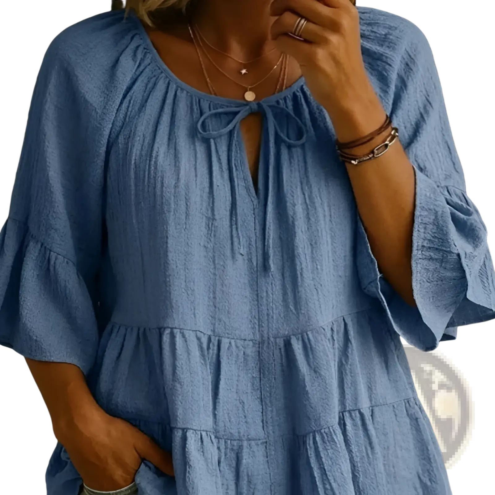 A soft blue cotton linen pleated blouse top with ruffled sleeves and a tiered skirt in textured fabric