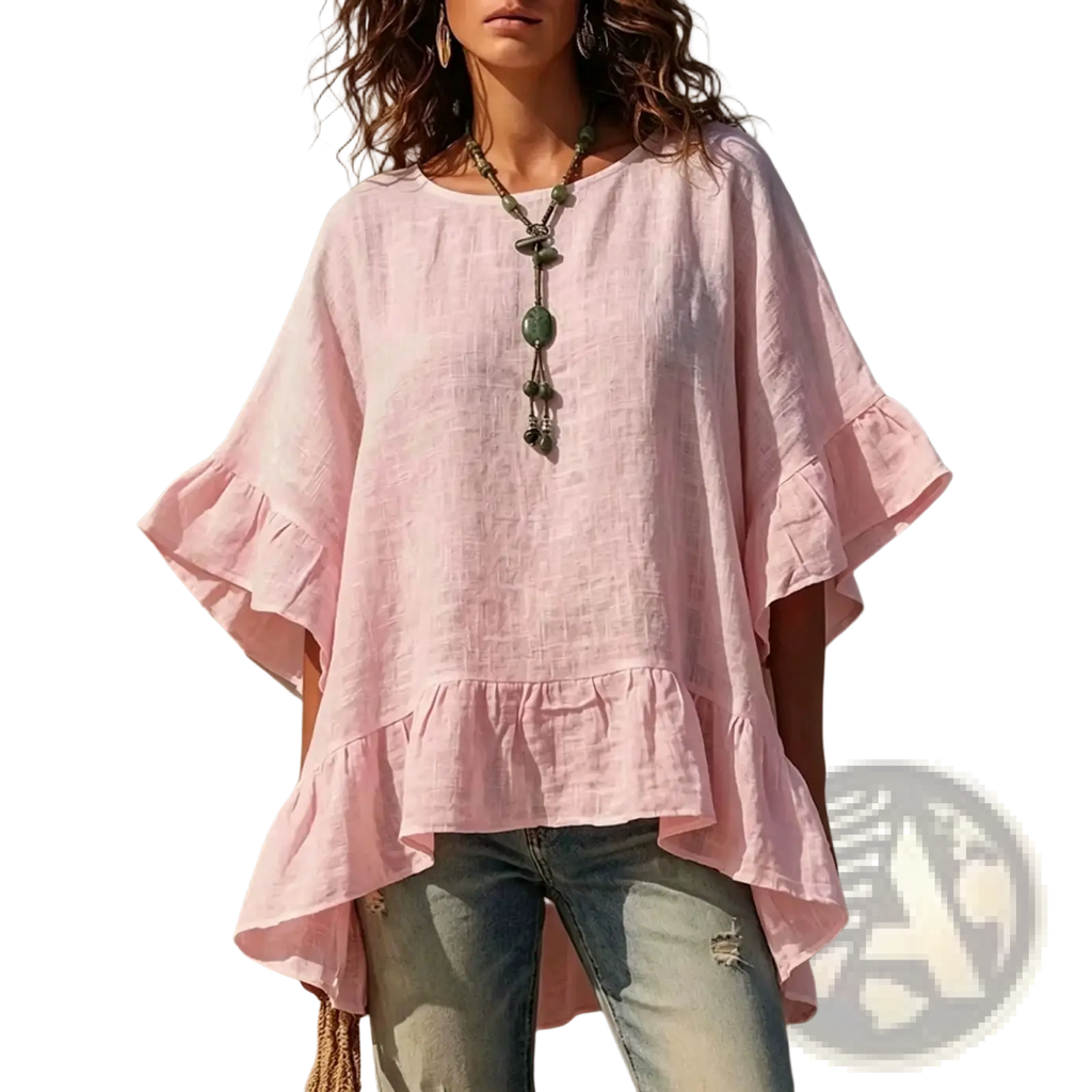 A soft pink cotton linen ruffle hem shirt with loose fit and textured fabric featuring ruffled sleeves and hem