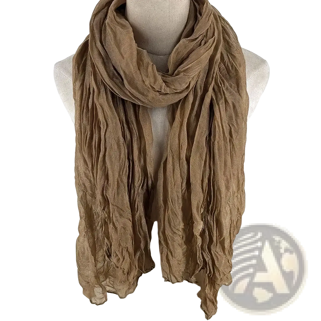 A soft crinkled tan cotton linen scarf for women draped elegantly as a breathable solid color shawl