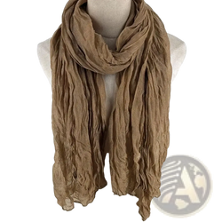 A soft crinkled tan cotton linen scarf for women draped elegantly as a breathable solid color shawl