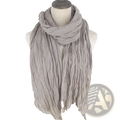 A soft light gray cotton linen scarf with crinkled texture draped elegantly as a solid color shawl for women