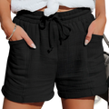 Black cotton linen wide leg shorts with a lightweight textured fabric, drawstring waist, and rolled cuffs