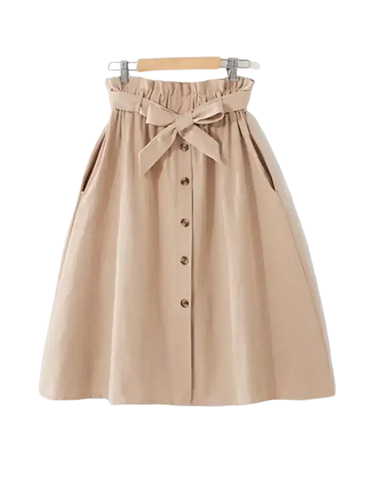 Beige cotton midi skirt with high waist gathered waistband front button closure and matching bow at the hip