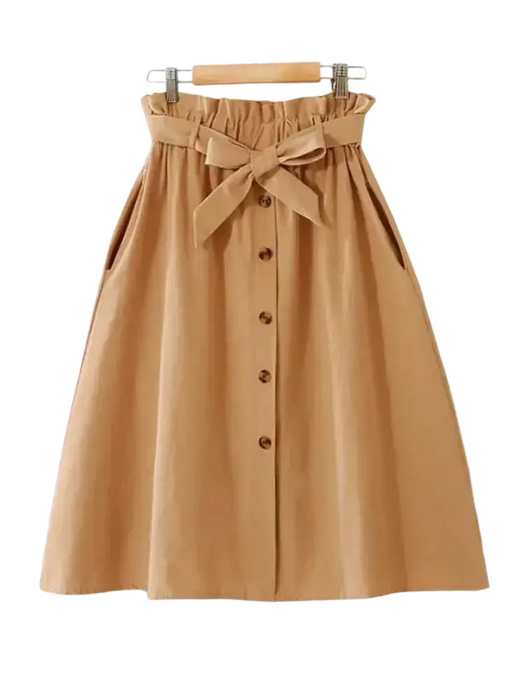 A tan cotton midi skirt with high waist, brown buttons down the front, and a matching fabric bow at the waist