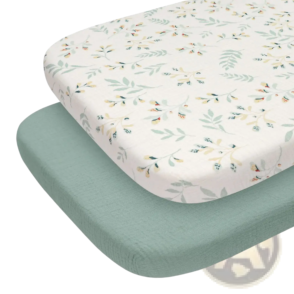 Cotton muslin fitted crib sheet set in soft cream with delicate botanical pattern in muted greens and yellows