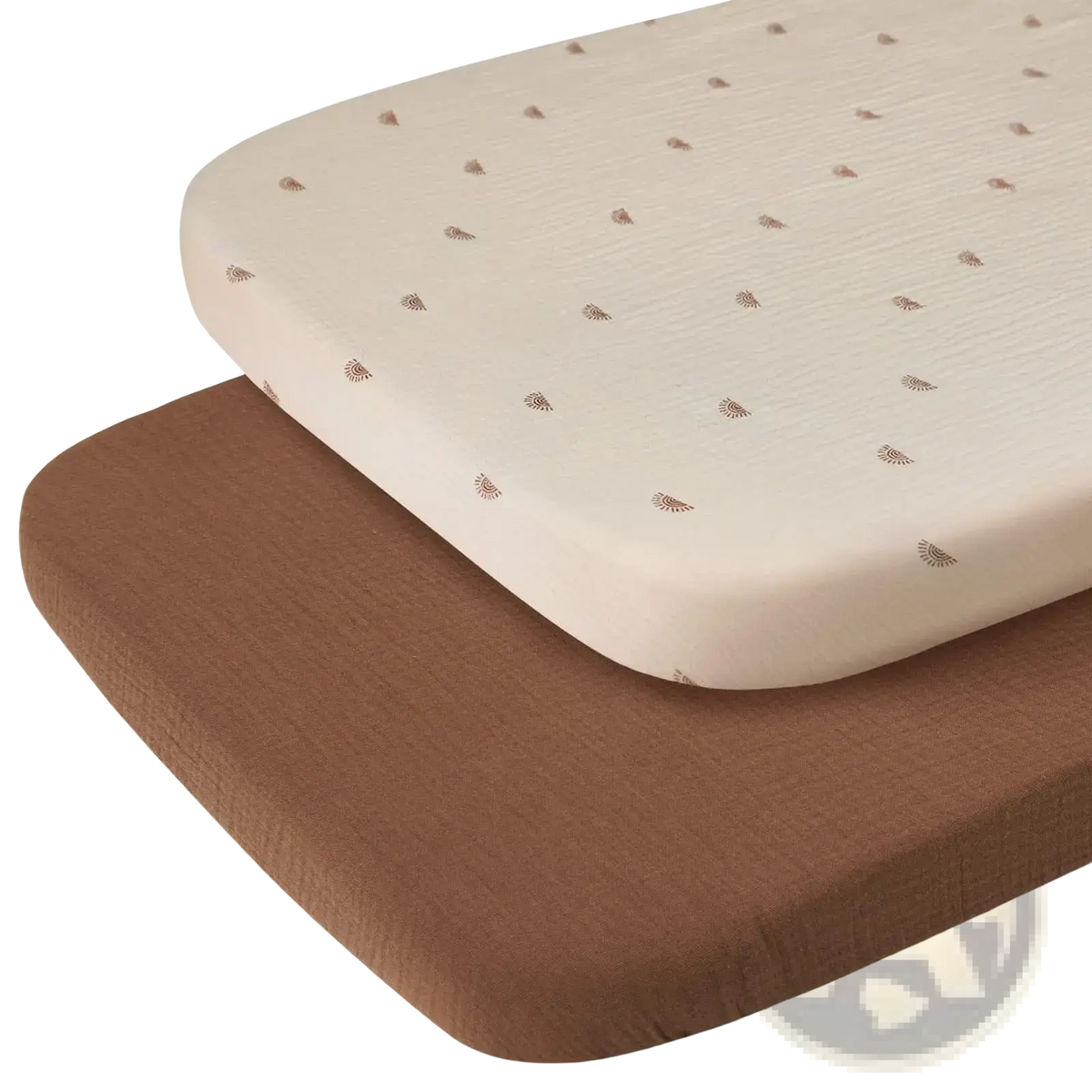 Cotton muslin crib sheet set with cream-colored sheet featuring subtle brown leaf patterns layered over solid brown