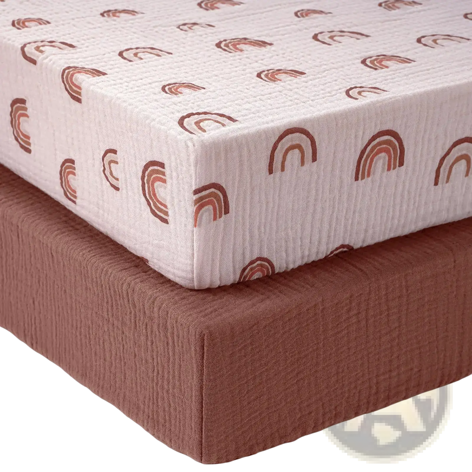 Cotton muslin crib sheet set featuring a soft off-white fabric with earthy-toned rainbow patterns for nursery use