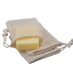 Beige mesh cotton soap saver bag with a yellow bar of soap inside for eco friendly soap storage and exfoliation