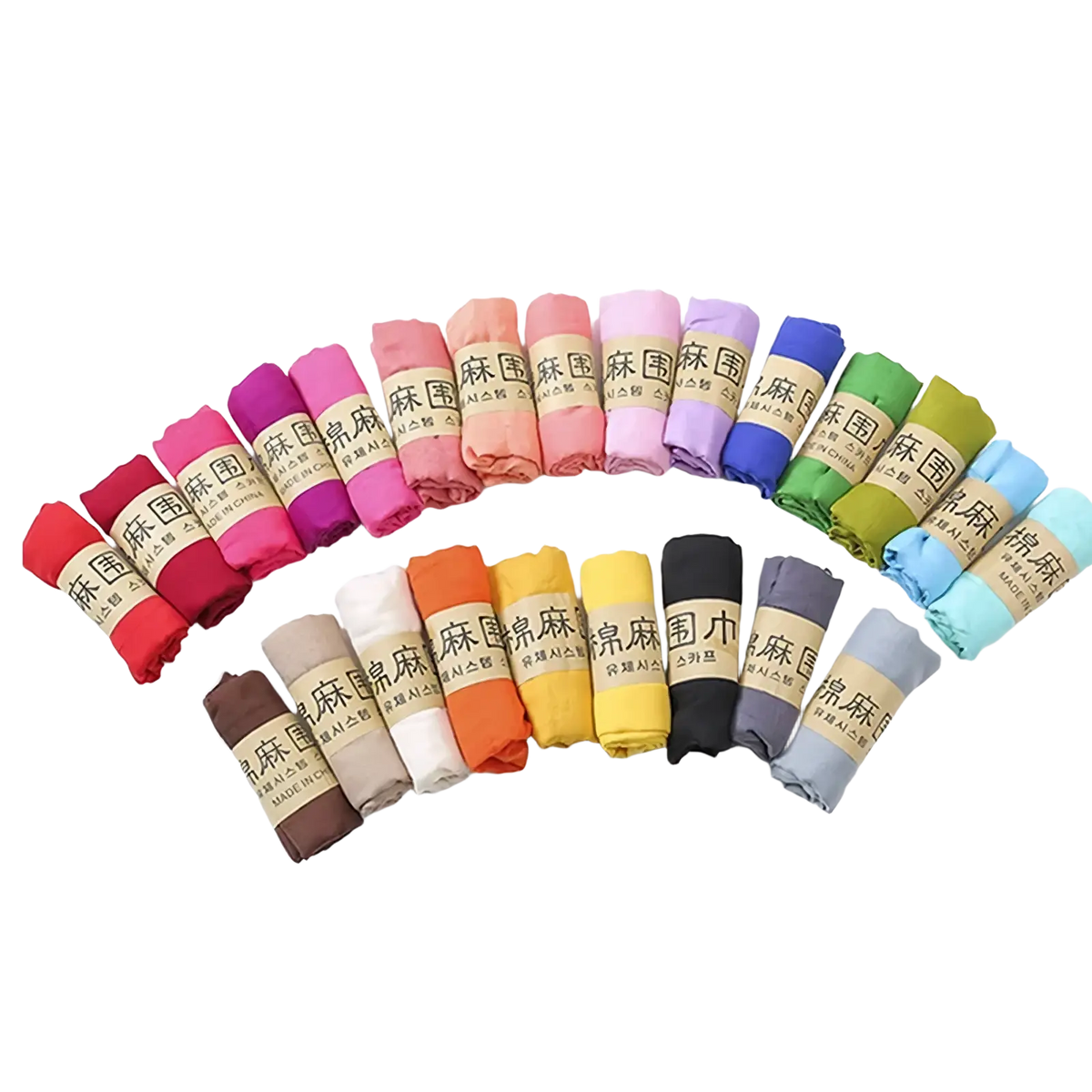 A colorful array of neatly rolled cotton winter scarves for women in solid warm hues including red pink purple and blue
