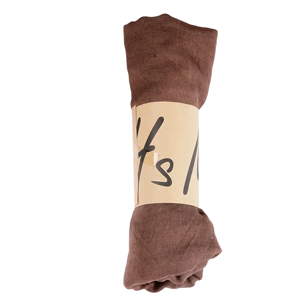A neatly rolled brown cotton winter scarf for women with a natural kraft paper band for solid warm shawl use