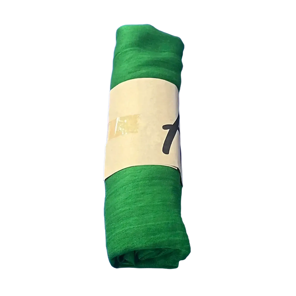 A rolled-up solid green cotton winter scarf with a white label, designed as a warm shawl for women