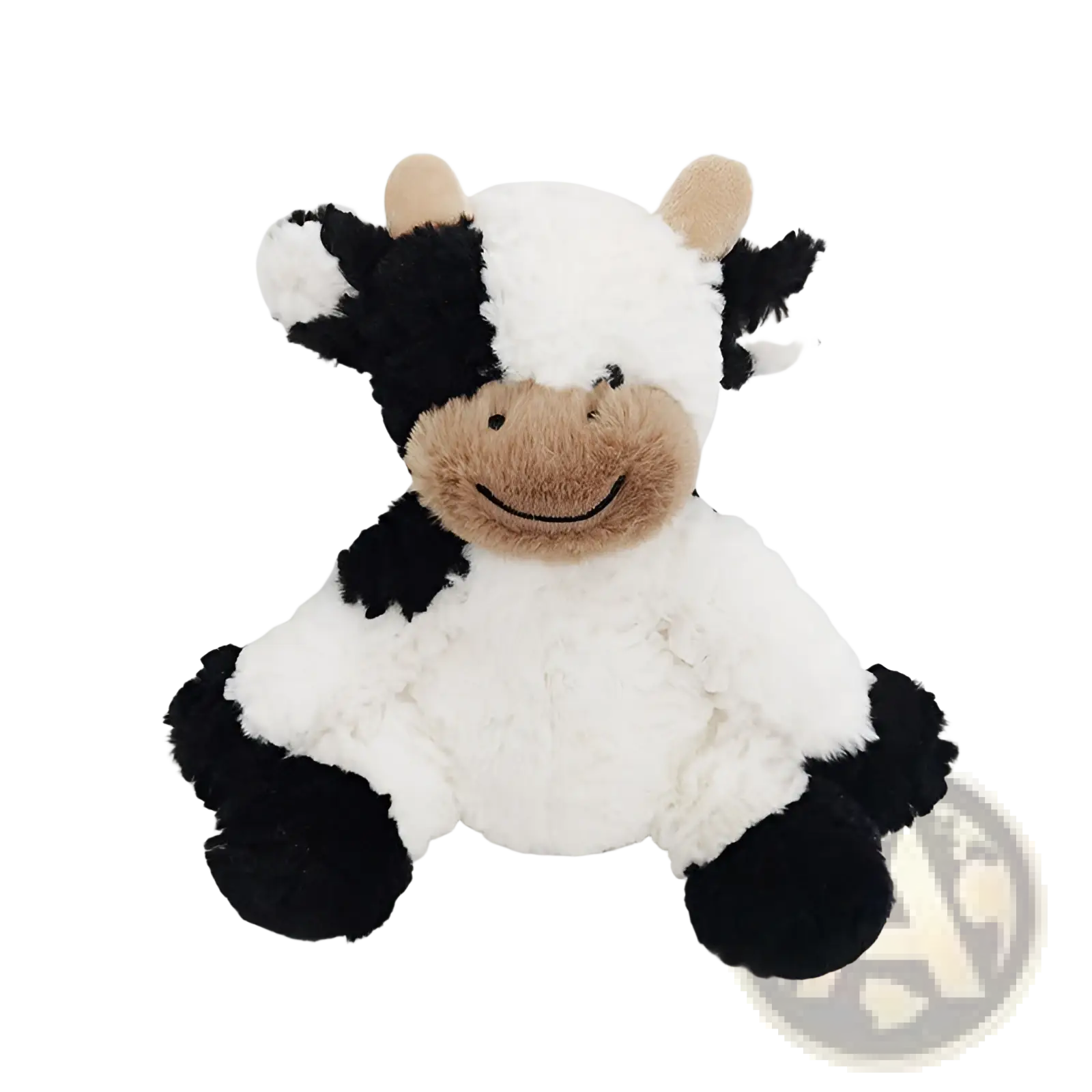 A plush black and white cow toy with tan face and soft textured fur sitting as a cute stuffed animal