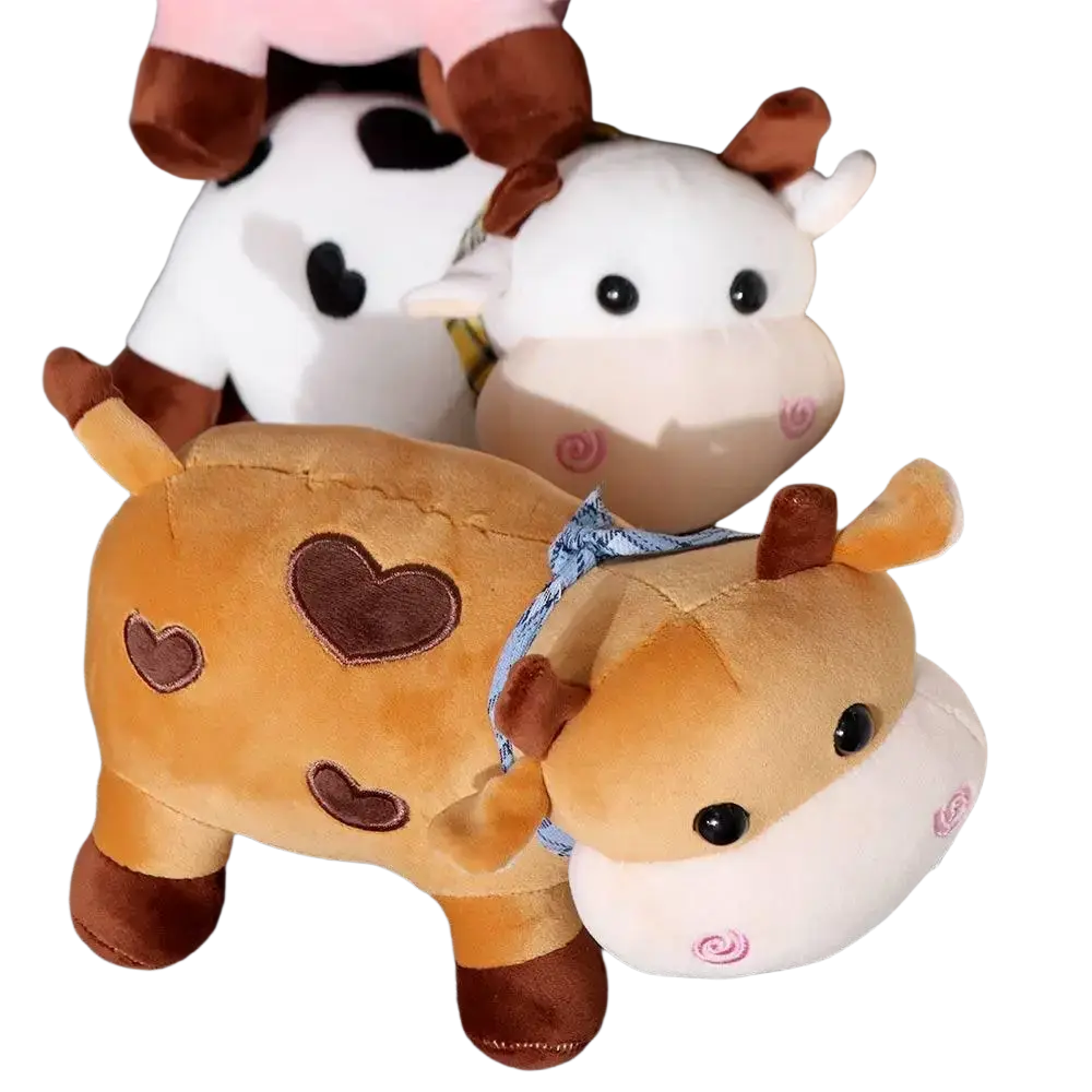 Plush giraffe toy with tan and brown velour fabric and embroidered hearts shown on the back side of cow plush toy