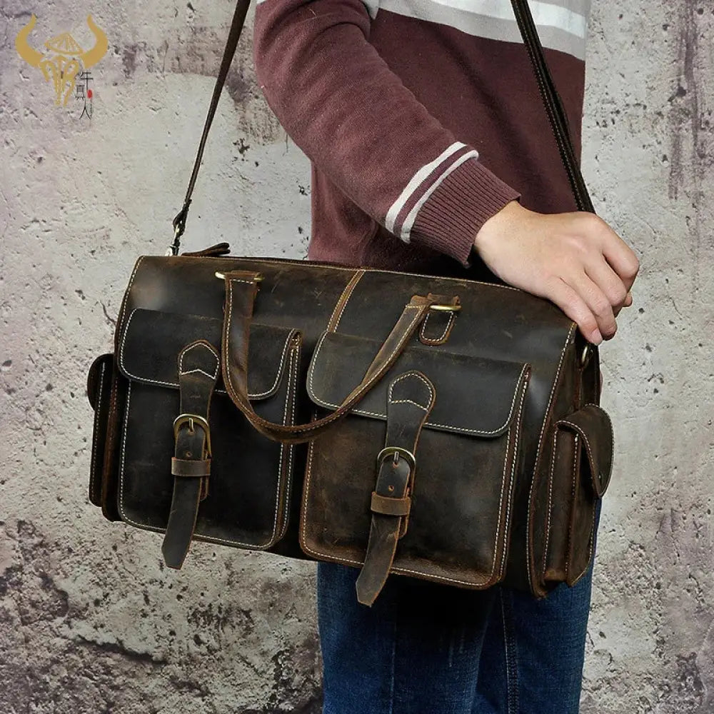 Vintage crazy horse leather satchel bag in dark brown with distressed texture multiple flap pockets and brass hardware