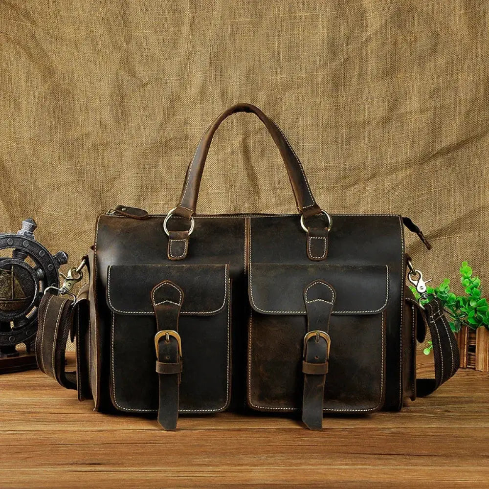 Vintage crazy horse leather satchel bag in dark brown with two front flap pockets and brass buckle hardware