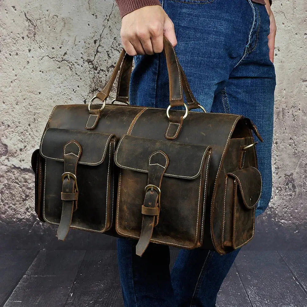 Dark brown vintage crazy horse leather satchel bag with brass hardware featuring two front flap pockets and sturdy handles
