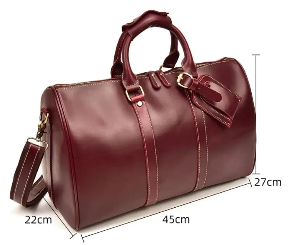 Burgundy crazy horse leather duffel tote bag with rich leather, white stitching, gold hardware, and detachable shoulder strap