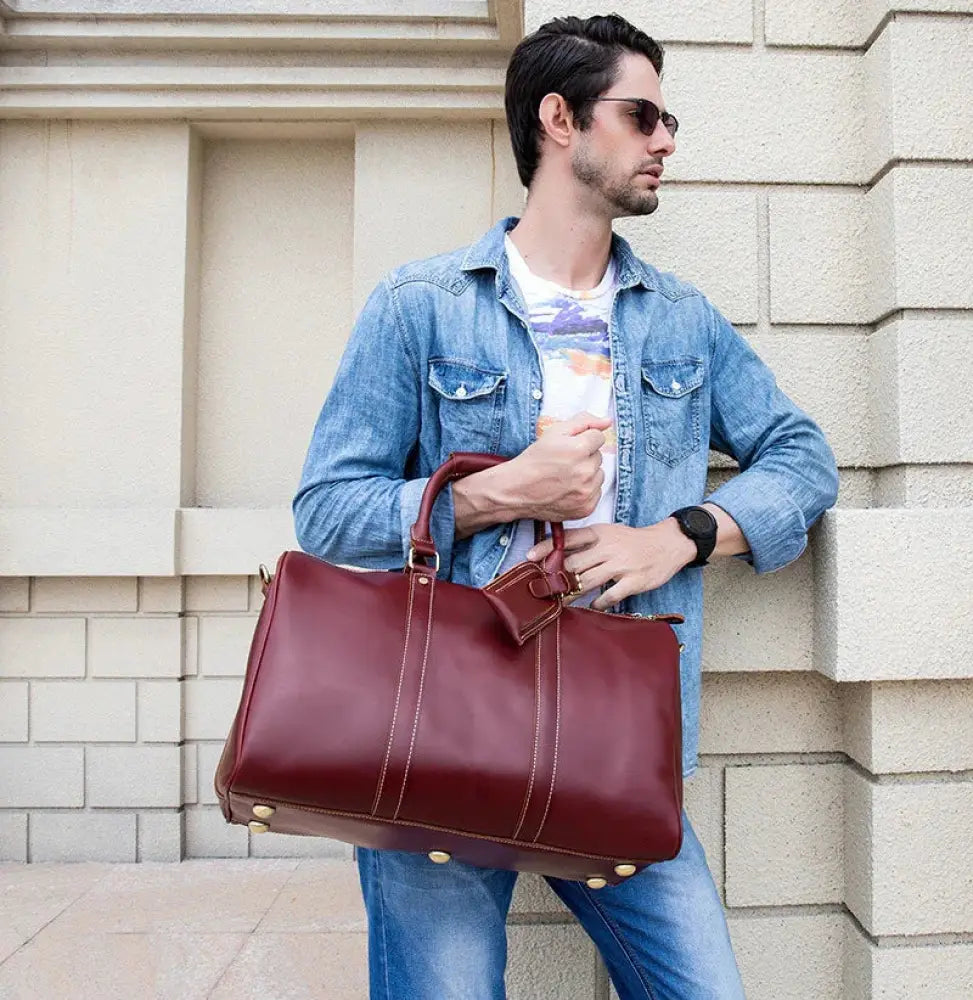 Burgundy crazy horse leather duffel tote bag with gold tone hardware and contrasting stitching