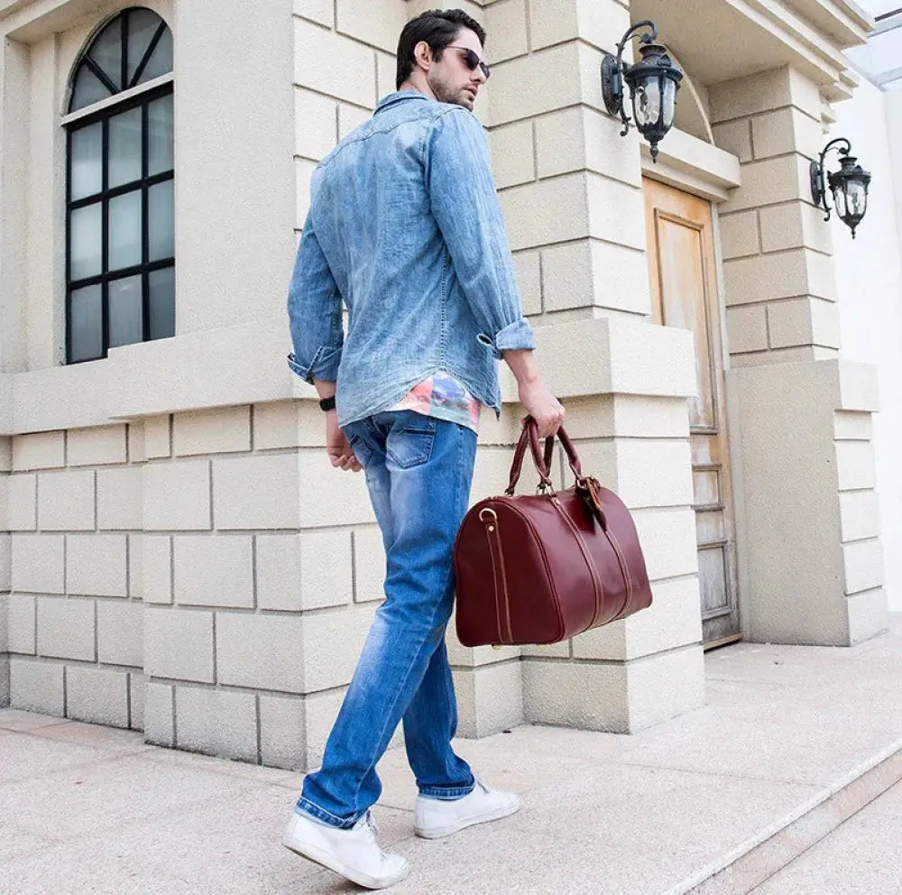 Burgundy crazy horse leather duffel tote bag with rich leather, sturdy handles, and classic rounded design