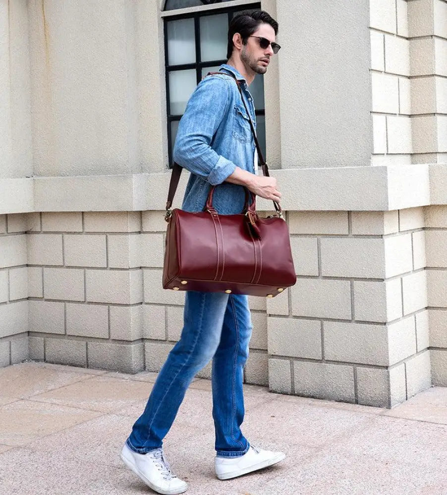 Burgundy crazy horse leather duffel tote bag with sturdy handles and gold tone hardware