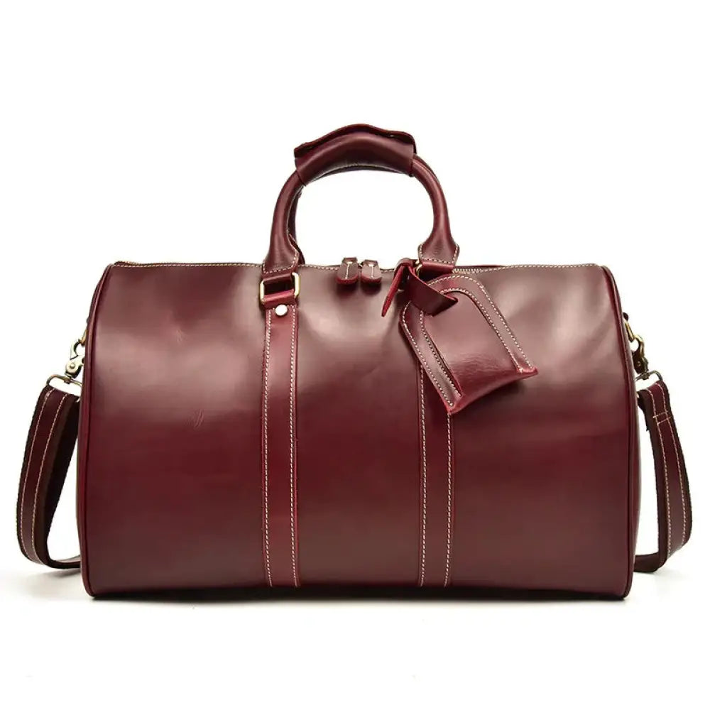 Burgundy crazy horse leather duffel tote bag with contrasting white stitching and matching leather tag